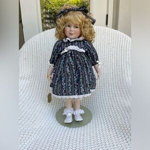 Porcelain doll from the Wimbledon Collection and stand included